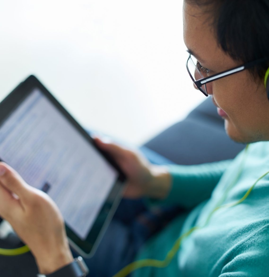 chinese-man-with-green-headphones-listens-podcast-P6FYVS5.jpg